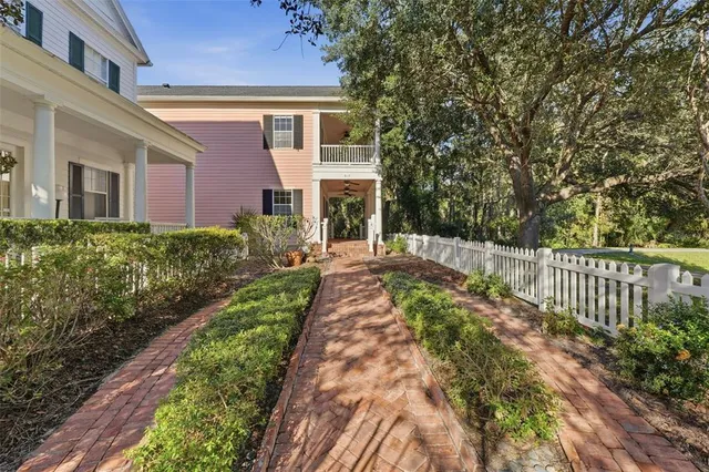 a view of a house with swimming pool next to a yard