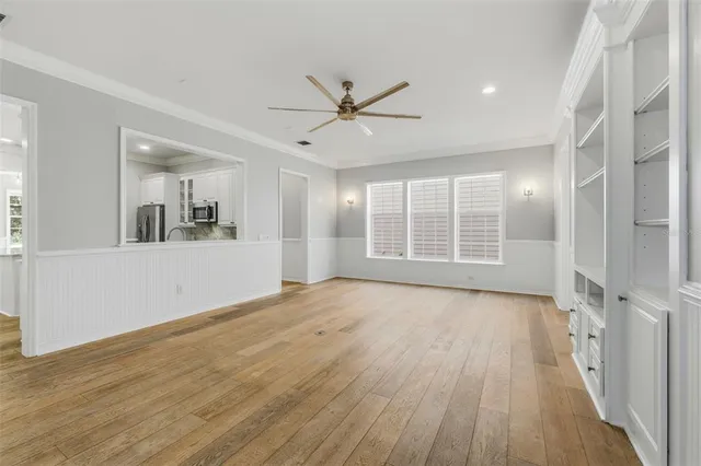 a view of a room with wooden floor and windows