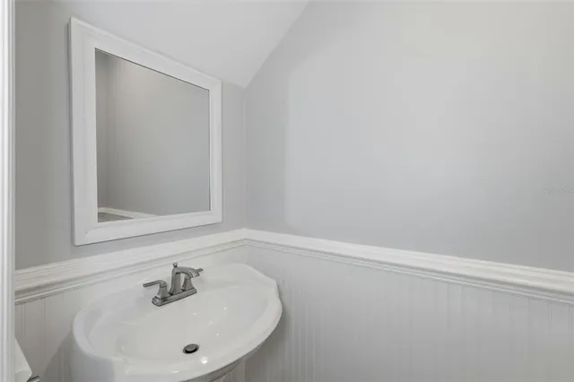 an empty room with wooden floor and a ceiling fan