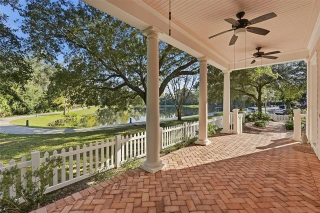 a view of an empty room with wooden floor and windows
