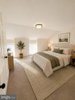 a bedroom with a large bed and potted plant