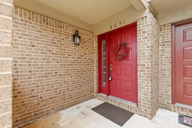 a view of a red door and a window