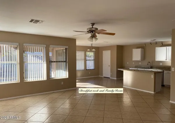 a view of an empty room with window and cabinet