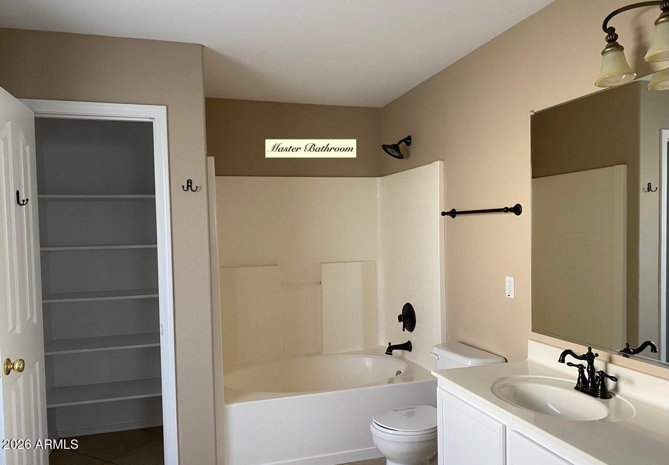 3427 East Derringer Way Gilbert, AZ 85297 - Photo 7 of 23 a bathroom with a sink a toilet and shower