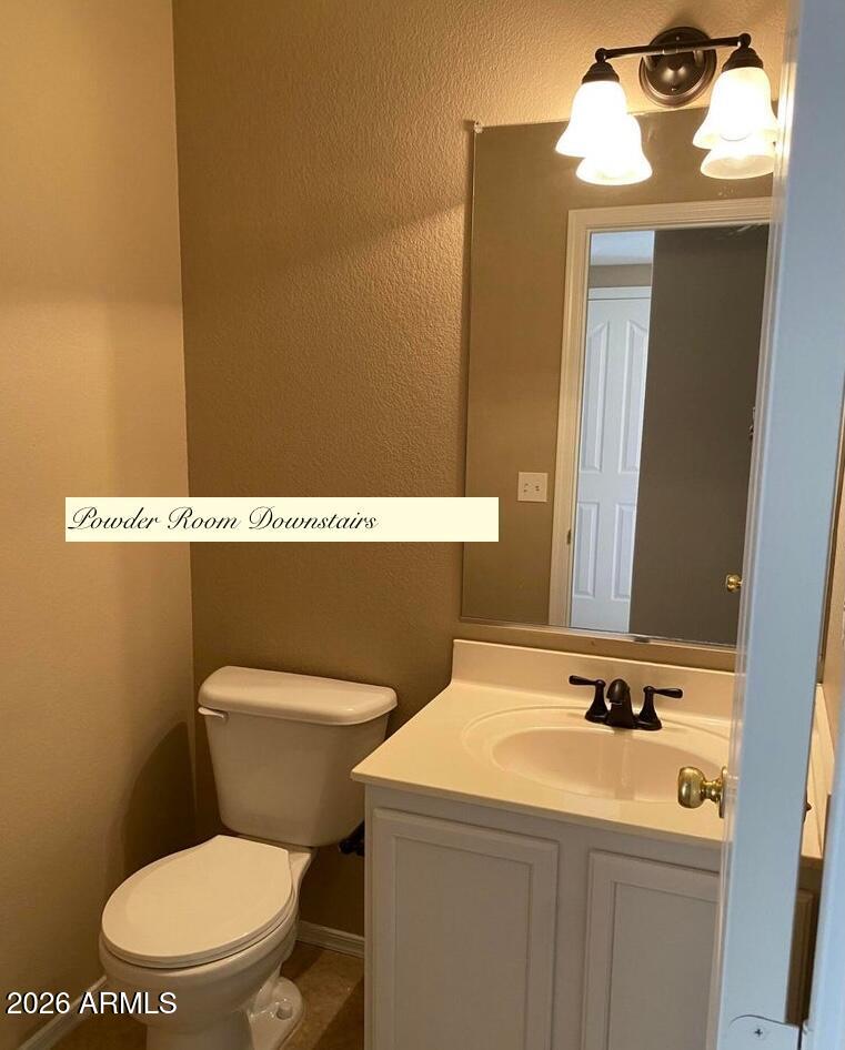 3427 East Derringer Way Gilbert, AZ 85297 - Photo 9 of 23 a bathroom with a toilet sink and mirror