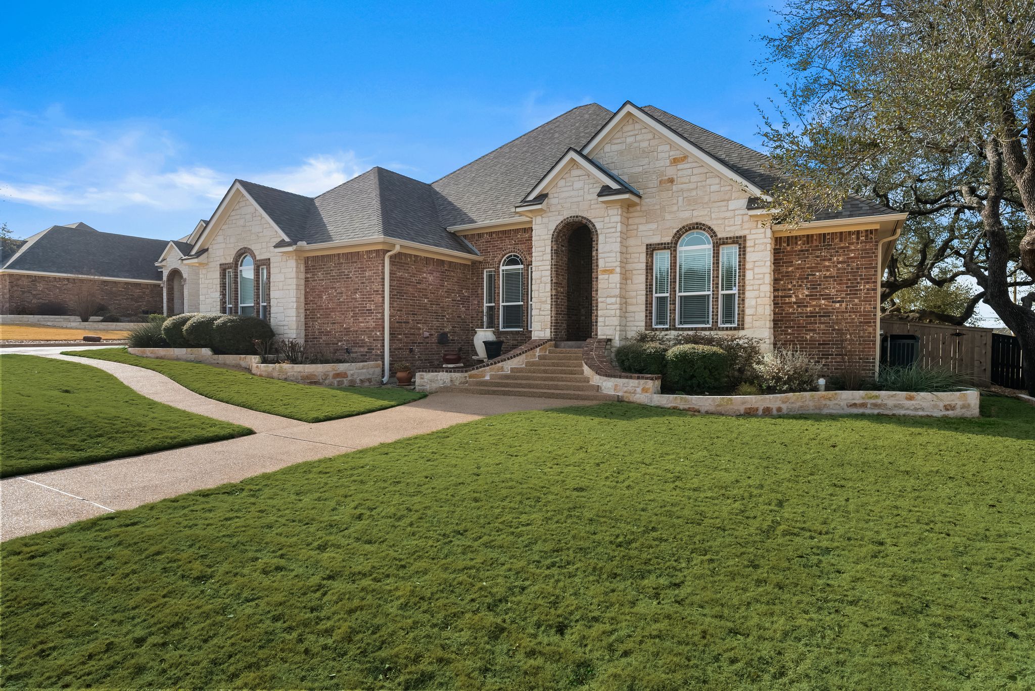 1735 Alta Vista Loop Temple, TX 76502 - Photo 3 of 38 a view of a white house with a big yard and large trees