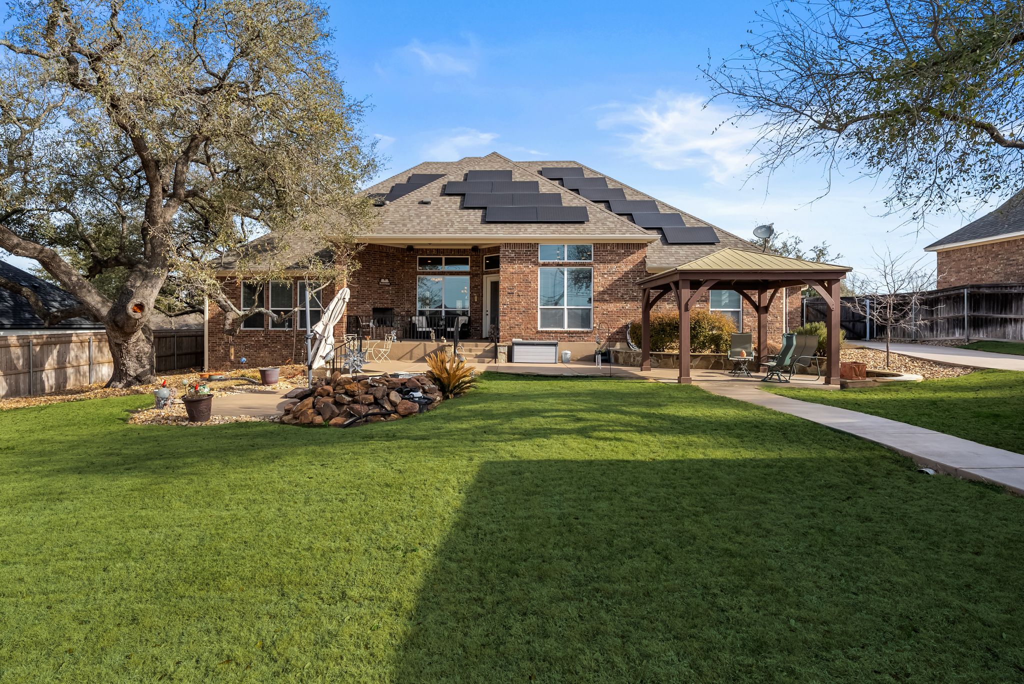 1735 Alta Vista Loop Temple, TX 76502 - Photo 33 of 38 a front view of a building with a garden and trees