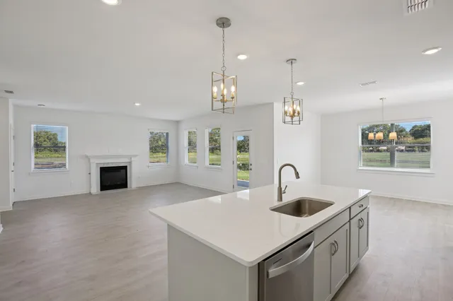 a kitchen with a sink and chandelier