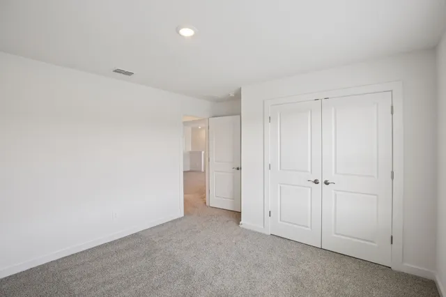 a bathroom with a bathtub shower sink vanity mirror and toilet