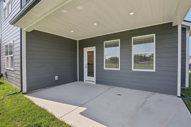a view of a house with a yard and sitting area