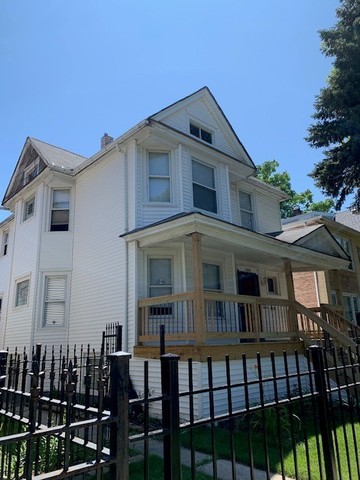 5929 West Rice Street Chicago, IL 60651 - Photo 1 of 29 a front view of a house with balcony