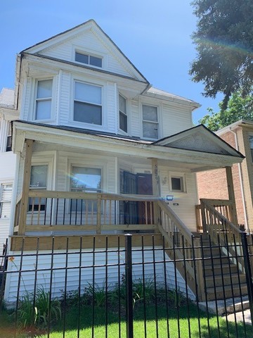 5929 West Rice Street Chicago, IL 60651 - Photo 2 of 29 a front view of a house with balcony