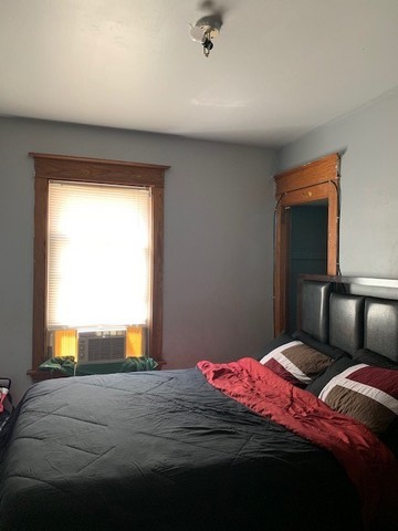 5929 West Rice Street Chicago, IL 60651 - Photo 11 of 29 a bedroom with a bed and window