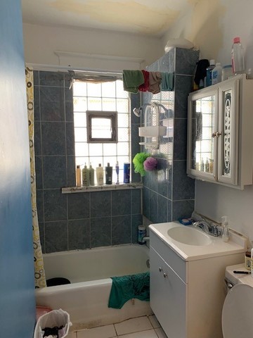 5929 West Rice Street Chicago, IL 60651 - Photo 12 of 29 a bathroom with a sink toilet and shower