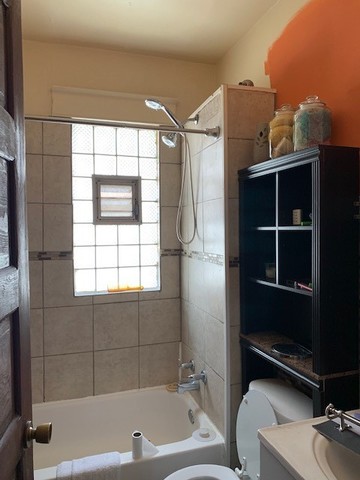 5929 West Rice Street Chicago, IL 60651 - Photo 16 of 29 a bathroom with a bathtub and a window