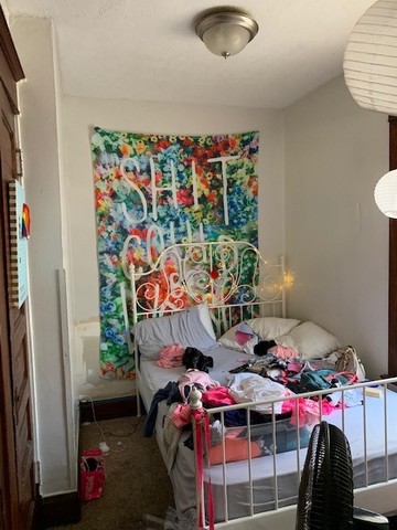 5929 West Rice Street Chicago, IL 60651 - Photo 17 of 29 a bed room with a bed and a table