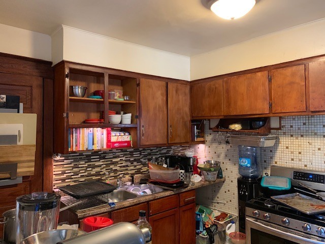 5929 West Rice Street Chicago, IL 60651 - Photo 18 of 29 a kitchen with stainless steel appliances granite countertop a stove and cabinets