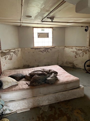 5929 West Rice Street Chicago, IL 60651 - Photo 20 of 29 a bed sitting in a bedroom next to a window