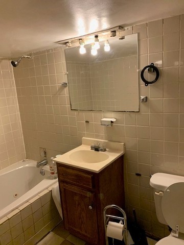 5929 West Rice Street Chicago, IL 60651 - Photo 25 of 29 a bathroom with a sink toilet and shower