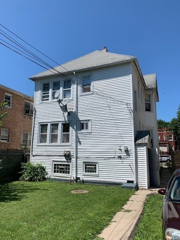 5929 West Rice Street Chicago, IL 60651 - Photo 26 of 29 a front view of a house with a garden