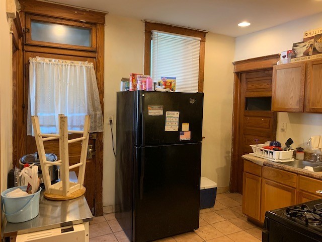 5929 West Rice Street Chicago, IL 60651 - Photo 8 of 29 a kitchen with a refrigerator and a stove