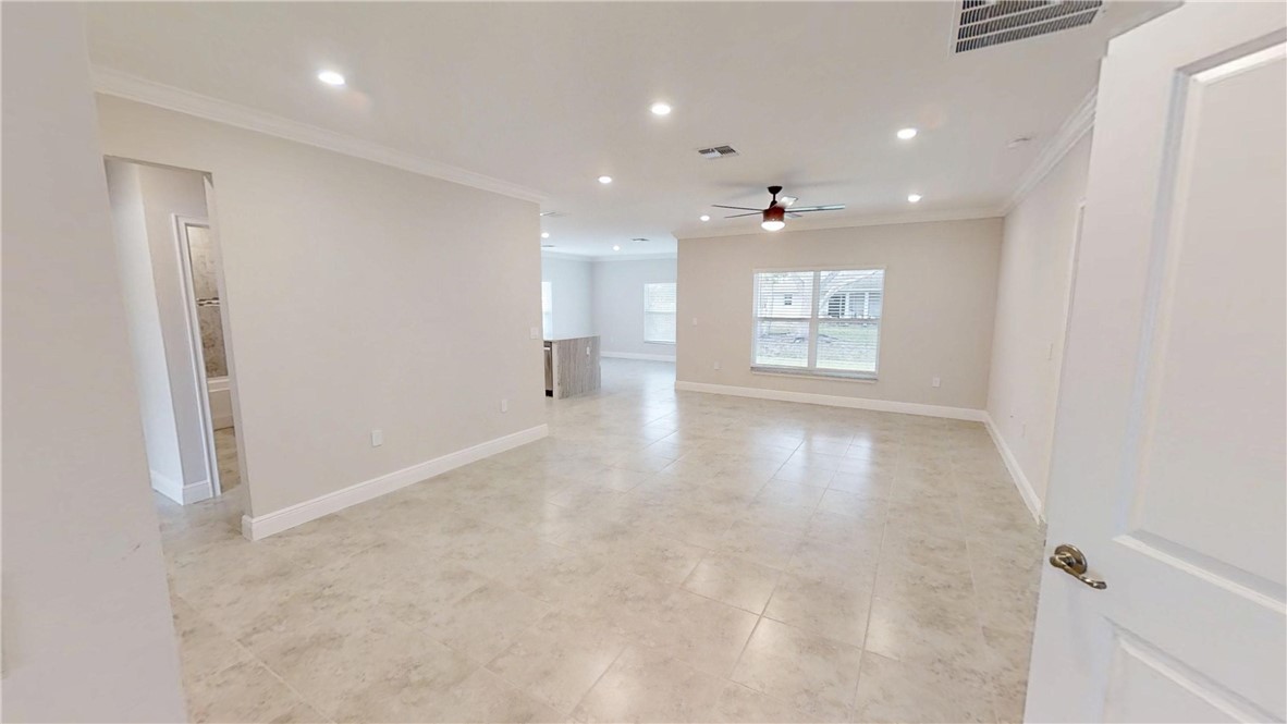 418 Easy Street Sebastian, FL 32958 - Photo 12 of 34 an empty room with windows and ceiling fan