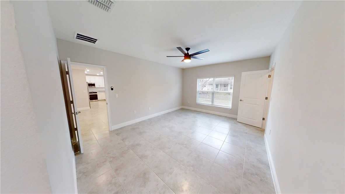 418 Easy Street Sebastian, FL 32958 - Photo 15 of 34 wooden floor in an empty room with a window