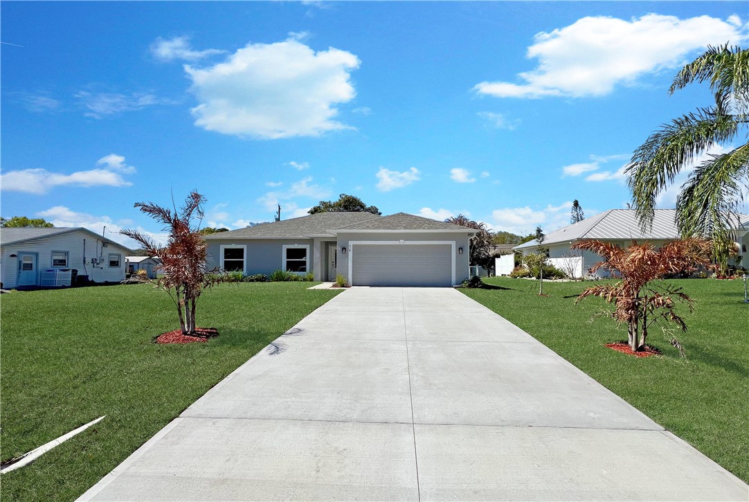 418 Easy Street Sebastian, FL 32958 - Photo 2 of 34 a front view of house with yard and green space