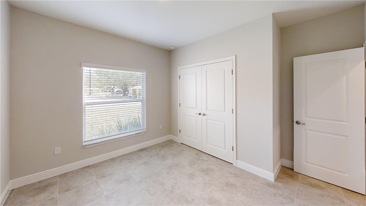 418 Easy Street Sebastian, FL 32958 - Photo 21 of 34 an empty room with windows