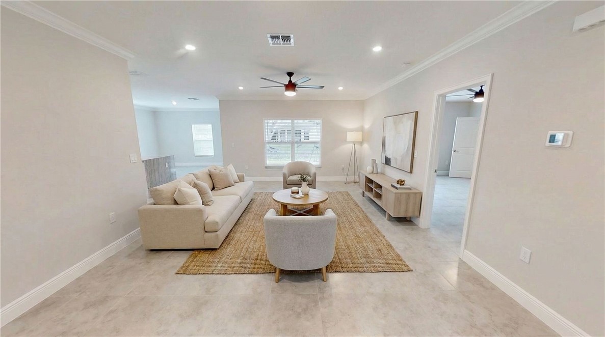 418 Easy Street Sebastian, FL 32958 - Photo 5 of 34 a living room with furniture and a chandelier