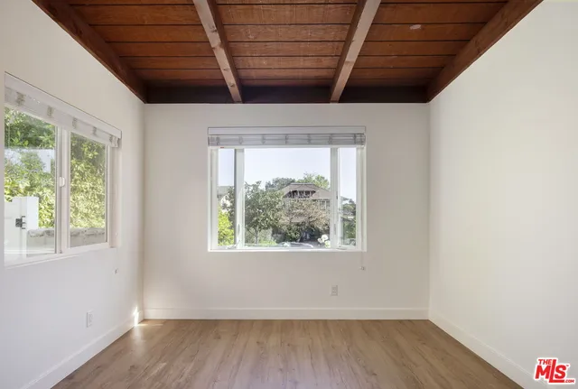 a view of a room with wooden floors and a window