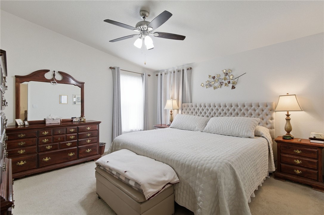 4342 Cordes Road Golden Valley, AZ 86413 - Photo 31 of 39 a spacious bedroom with a bed and a chandelier