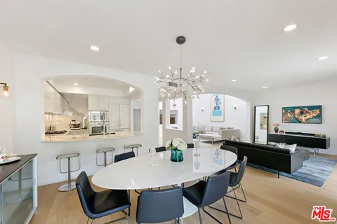 a large kitchen with a table and chairs