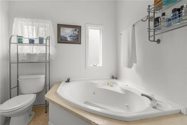 a white bath tub sitting next to a white toilet