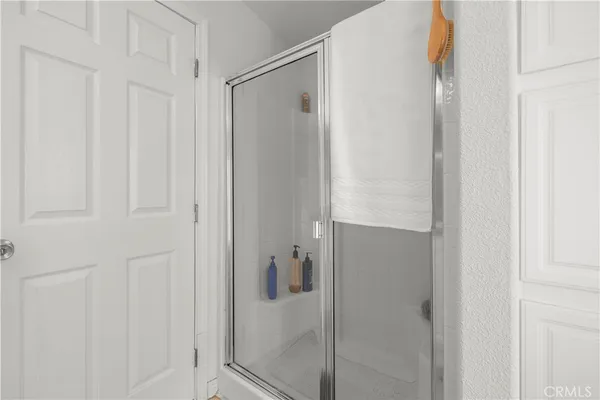 a bathroom with a glass shower door