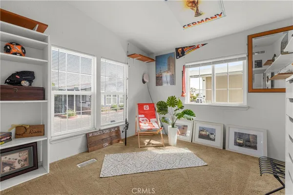 a living room filled with furniture and a window