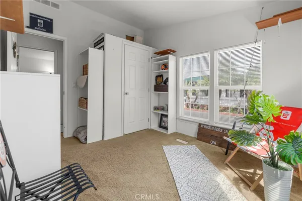 a bedroom with furniture and a potted plant