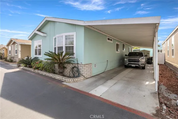 a view of a house with a car parked in front of it