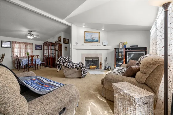 a living room with furniture fireplace and a window