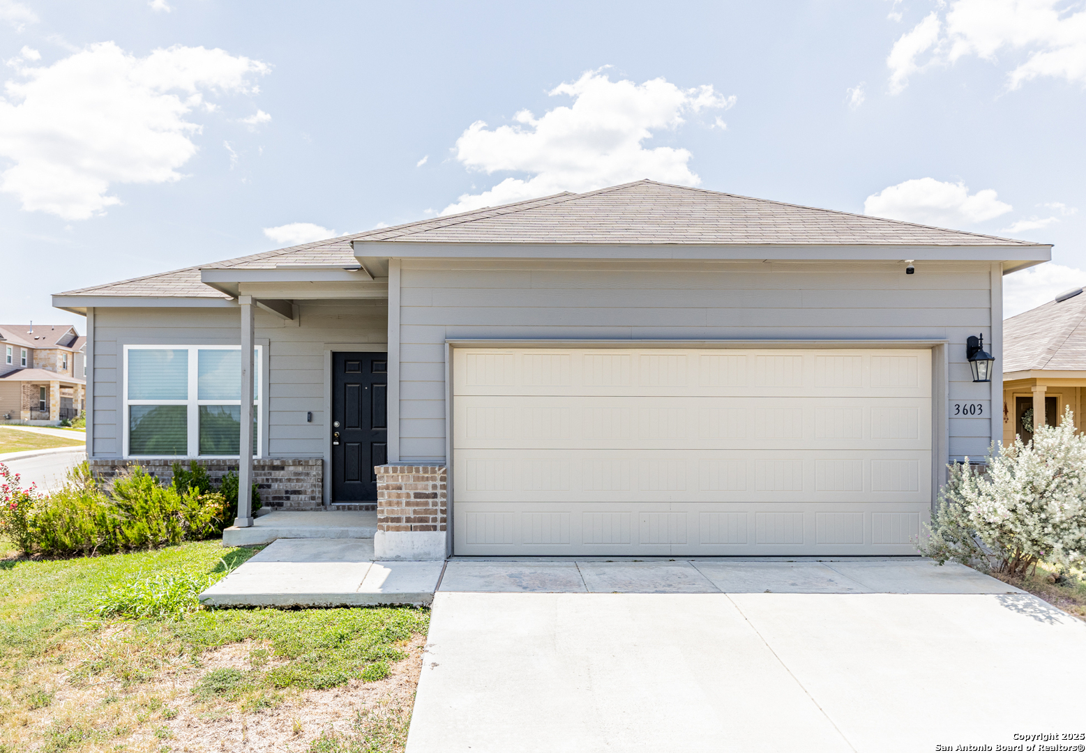 a front view of a house with a yard and garage