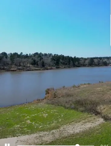 a view of a lake with a house in the background