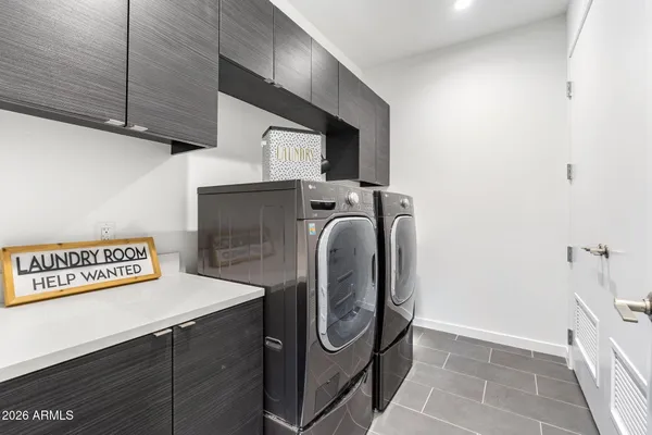 a kitchen with sink and chairs