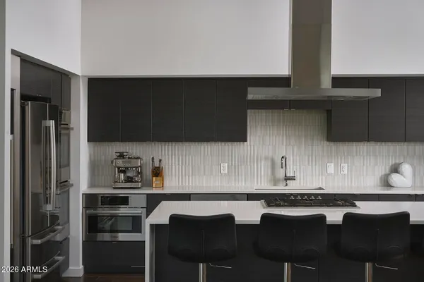 a kitchen with stainless steel appliances a sink and a stove