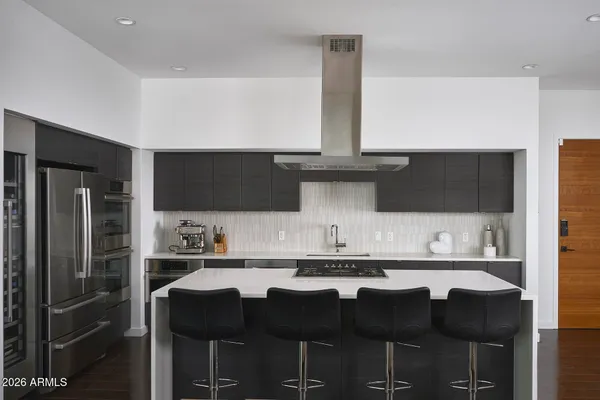 a kitchen with cabinets a sink and stainless steel appliances