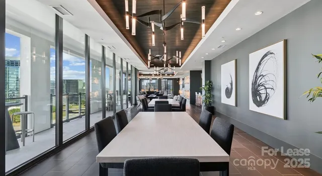 a view of a hallway with furniture and chandelier