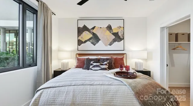 a bedroom with a bed and glass window