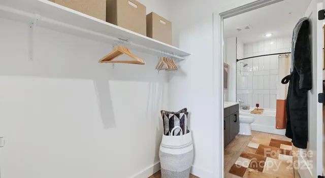 a white toilet sitting next to a bathroom sink and a mirror