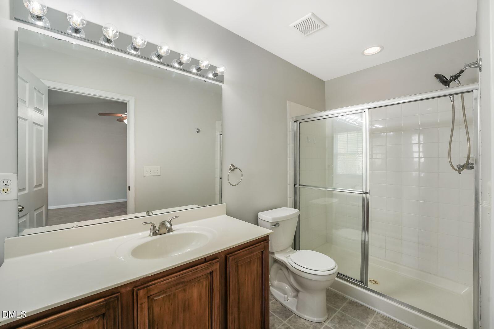 4909 Blue Rock Court Raleigh, NC 27610 - Photo 14 of 15 a bathroom with a sink toilet and shower