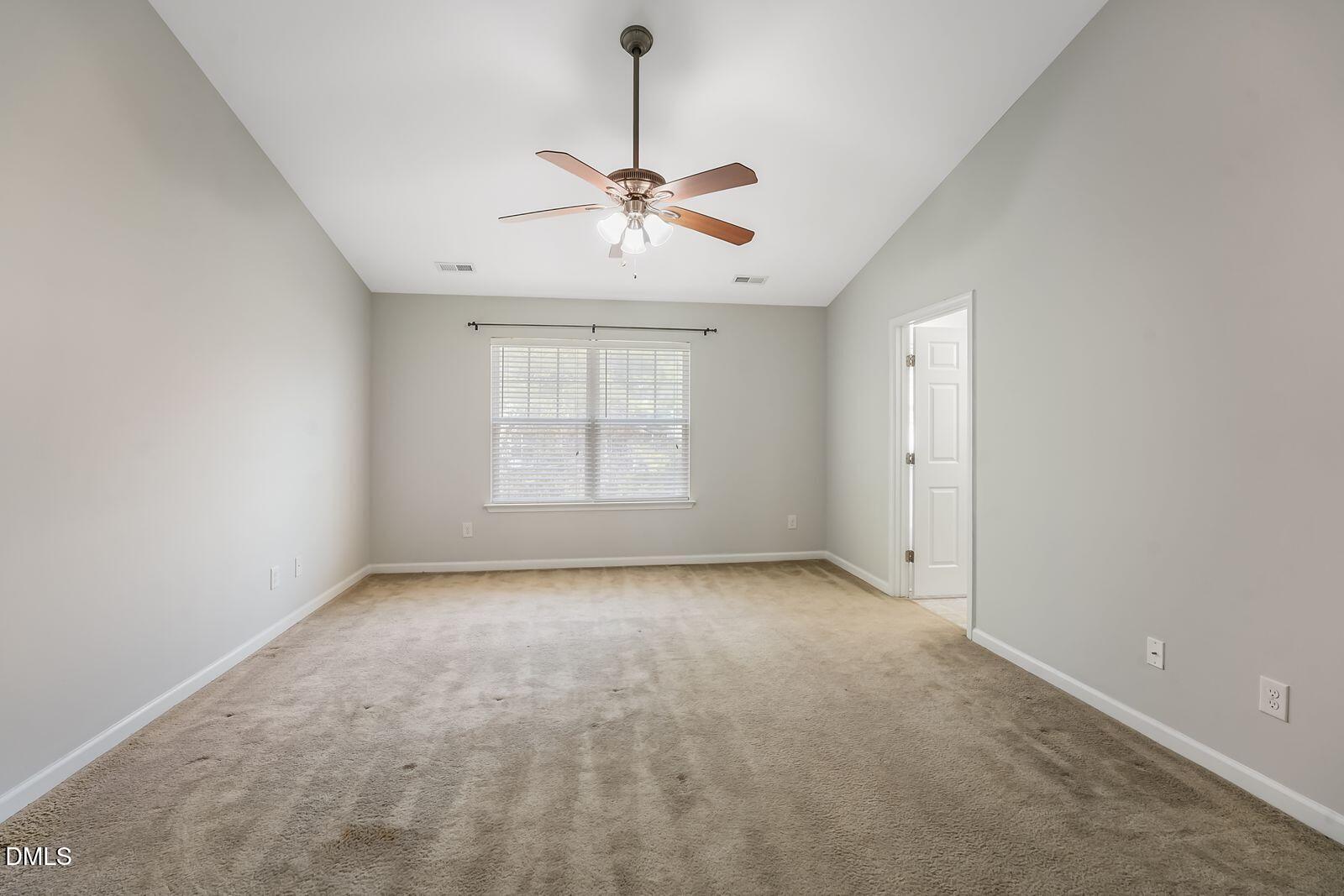 4909 Blue Rock Court Raleigh, NC 27610 - Photo 15 of 15 an empty room with windows and fan