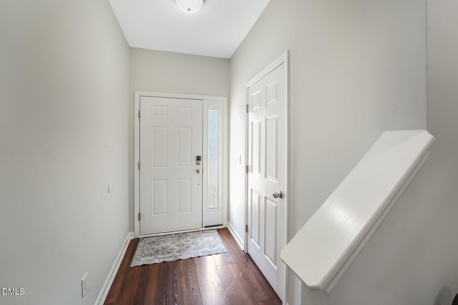 4909 Blue Rock Court Raleigh, NC 27610 - Photo 3 of 15 a view of a hallway with wooden floor and staircase